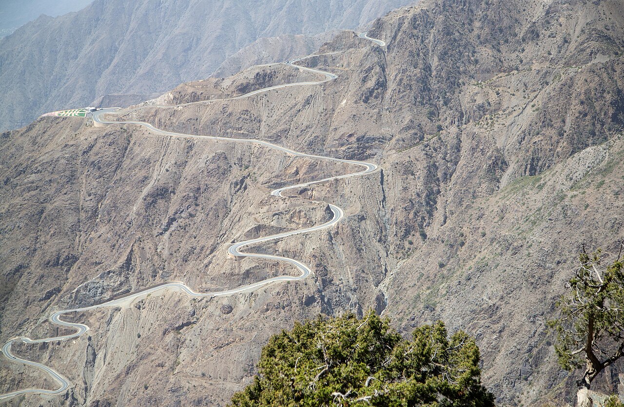 A real photograph of the rocky peaks and green valleys of the Sarawat Mountains in western Saudi Arabia